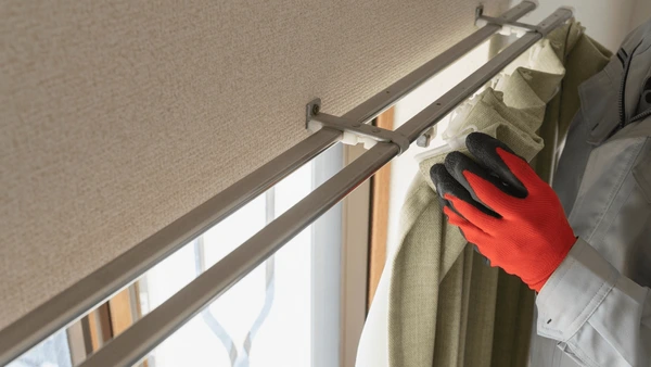 male-worker-who-installs-curtain-600nw-2252400307